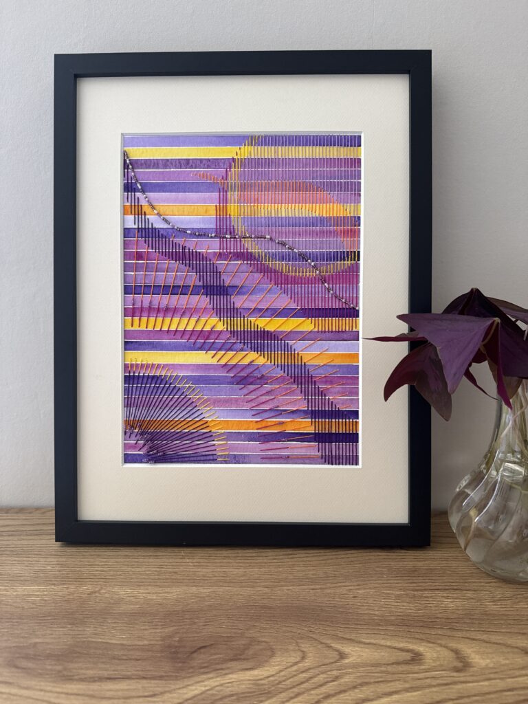 Tableau en aquarelle brodée avec fils de coton et perles dans une palette de violets.